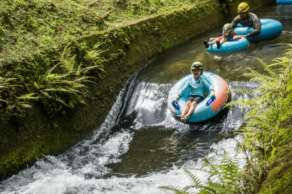 A family floating through a flume on the Kauai tubing adventure